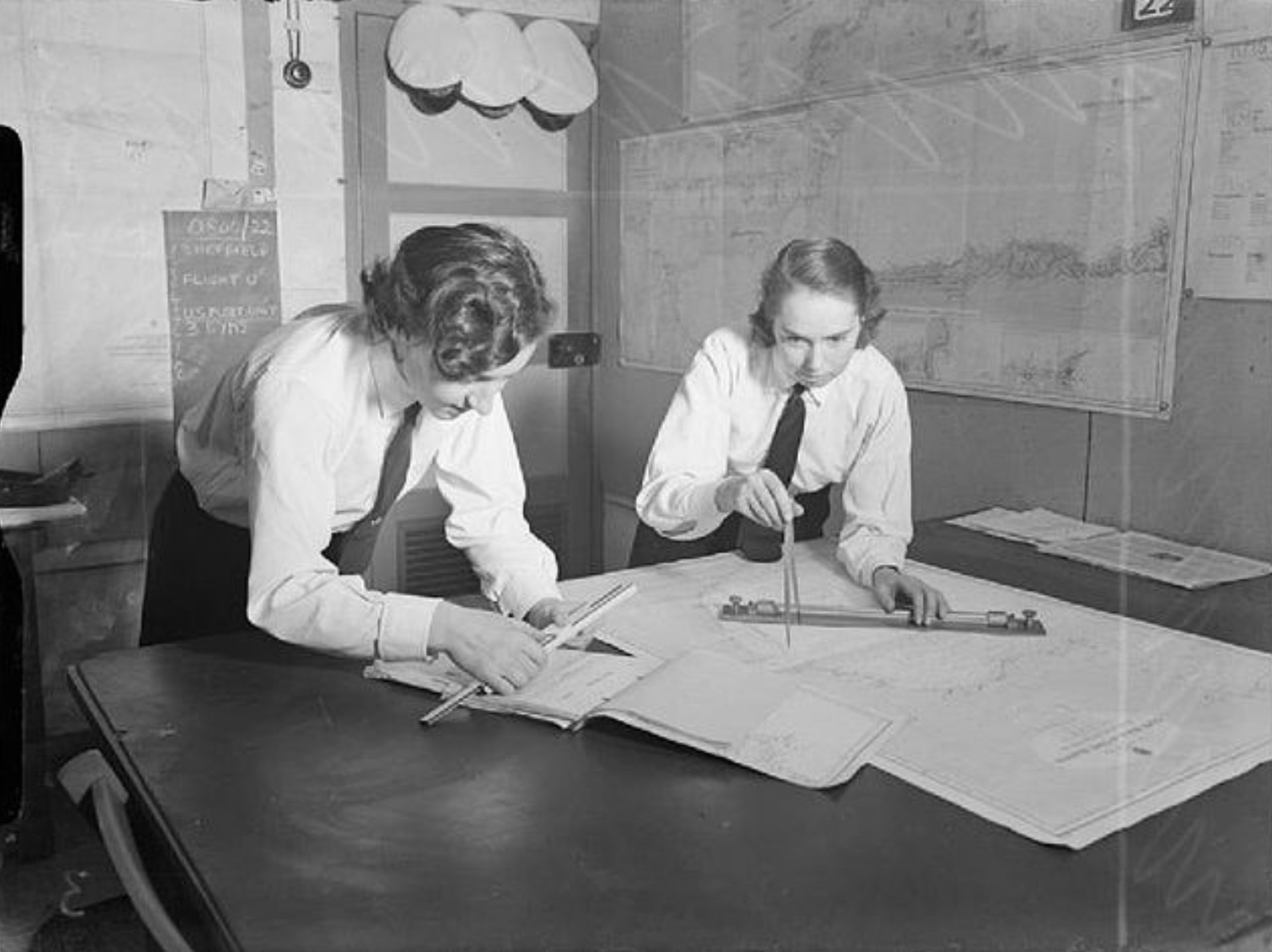 Women's Royal Naval Service officers working on a chart in the Naval operations room in Gibraltar 